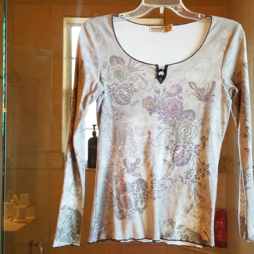 One world grey top with pink rhinestones.